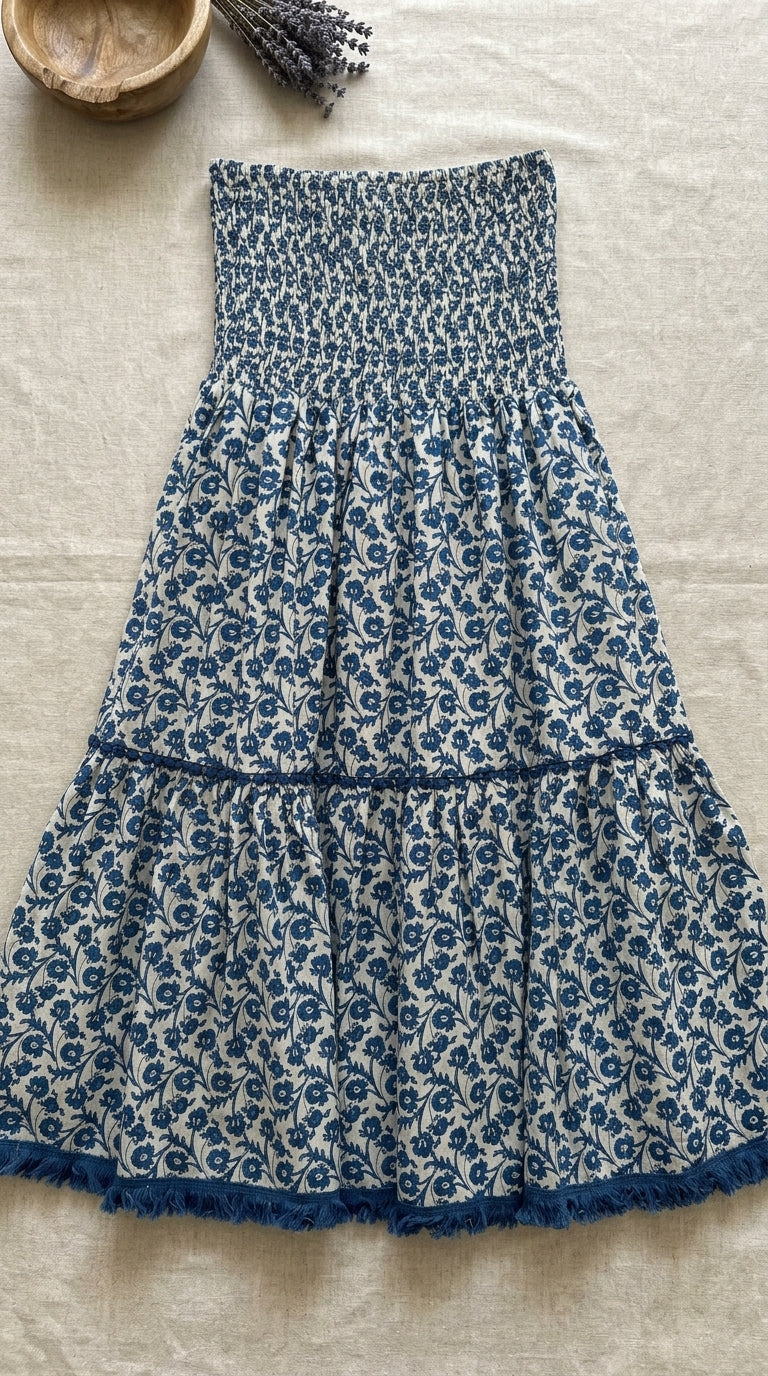 Indigo floral  print smocked skirt-dress flat lay showing fringe hem detail