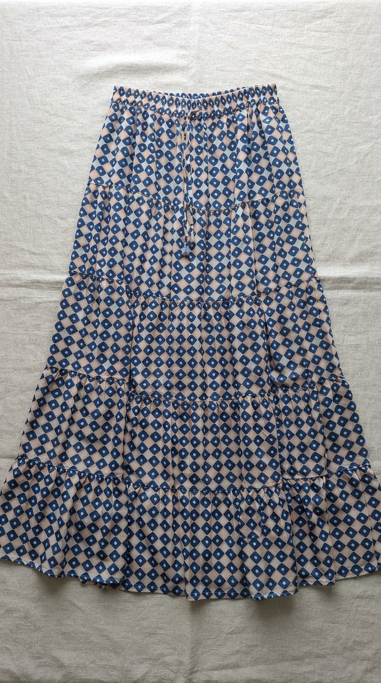 Navy and sand geometric tiered maxi skirt flat lay showing drawstring waist and ruffle hem