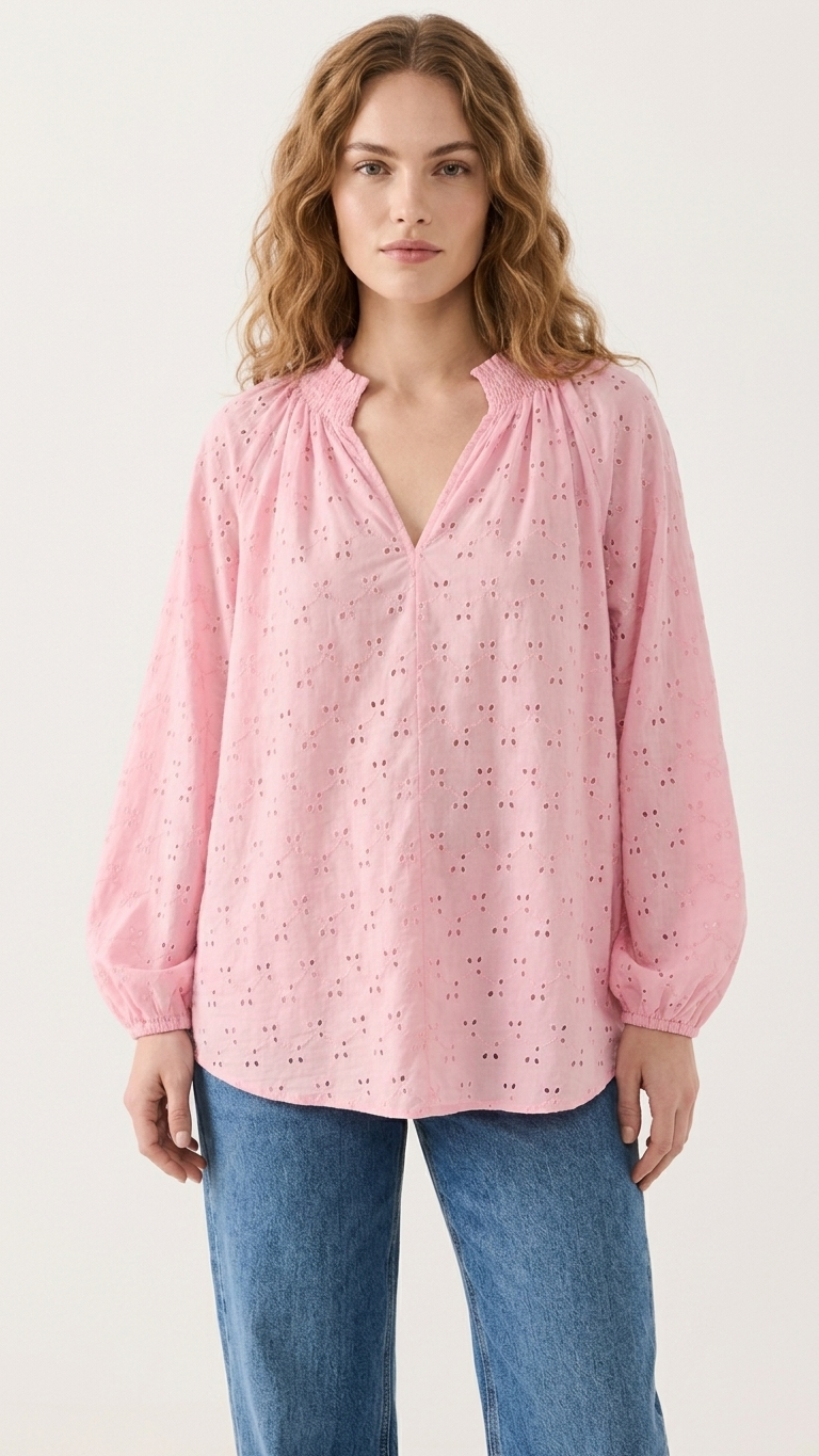 Pink eyelet cotton blouse with smocked collar, styled with denim jeans